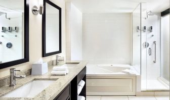 Guest bathroom with shower and bath at Four Points By Sheraton Mississauga Meadowvale.