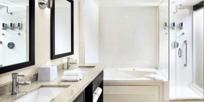 Guest bathroom with shower and bath at Four Points By Sheraton Mississauga Meadowvale.