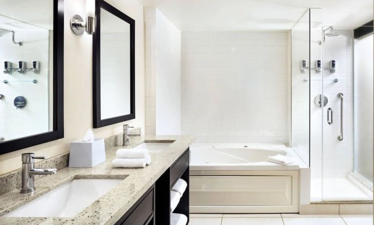 Guest bathroom with shower and bath at Four Points By Sheraton Mississauga Meadowvale.