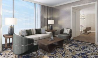 Spacious king room with lounge area at Hilton BNA Nashville Airport Terminal.