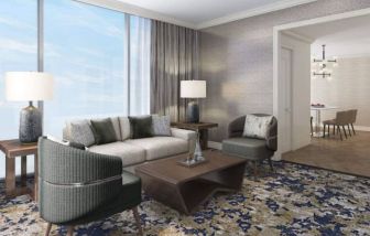 Spacious king room with lounge area at Hilton BNA Nashville Airport Terminal.