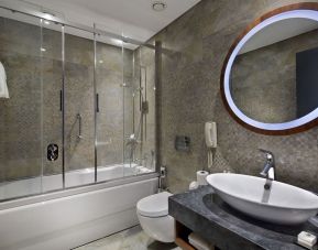 Guest bathroom with shower and bath at DoubleTree By Hilton Istanbul - Piyalepasa.