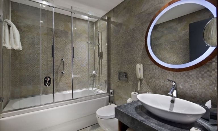 Guest bathroom with shower and bath at DoubleTree By Hilton Istanbul - Piyalepasa.