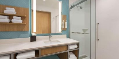 Guest bathroom with shower at Hilton Garden Inn Nashville West End Avenue.