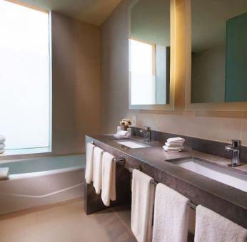 Guest bathroom with bath at Hilton Garden Inn Monterrey Airport, Nuevo Leon, Mexico.