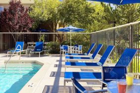 Outdoor pool and pool chairs at Sonesta ES Suites Auburn Hills Detroit.