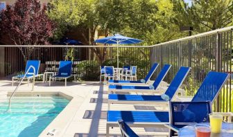 Outdoor pool and pool chairs at Sonesta ES Suites Auburn Hills Detroit.