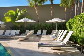 Outdoor pool with pool chairs at Sonesta Fort Lauderdale Beach.