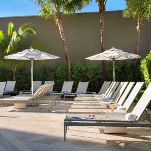 Outdoor pool with pool chairs at Sonesta Fort Lauderdale Beach.