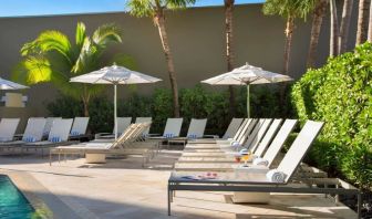 Outdoor pool with pool chairs at Sonesta Fort Lauderdale Beach.