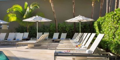 Outdoor pool with pool chairs at Sonesta Fort Lauderdale Beach.