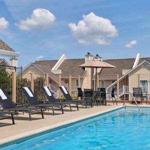 Outdoor pool with pool chairs at Sonesta ES Suites Cincinnati - Blue Ash.