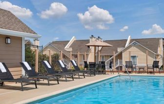 Outdoor pool with pool chairs at Sonesta ES Suites Cincinnati - Blue Ash.