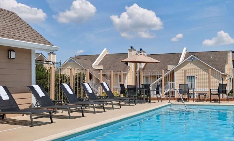 Outdoor pool with pool chairs at Sonesta ES Suites Cincinnati - Blue Ash.