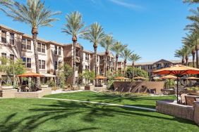 Hotel exterior with garden at Sonesta Suites Scottsdale Gainey Ranch.