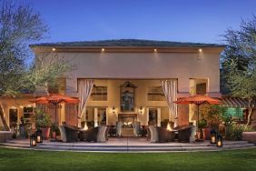 Hotel exterior with outdoor seating at Sonesta Suites Scottsdale Gainey Ranch.