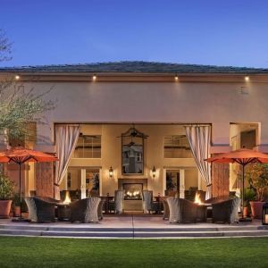 Hotel exterior with outdoor seating at Sonesta Suites Scottsdale Gainey Ranch.