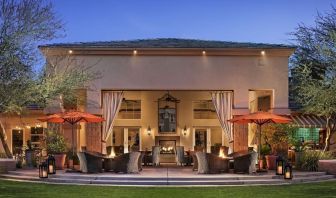 Hotel exterior with outdoor seating at Sonesta Suites Scottsdale Gainey Ranch.