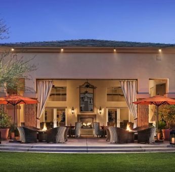 Hotel exterior with outdoor seating at Sonesta Suites Scottsdale Gainey Ranch.