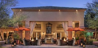 Hotel exterior with outdoor seating at Sonesta Suites Scottsdale Gainey Ranch.