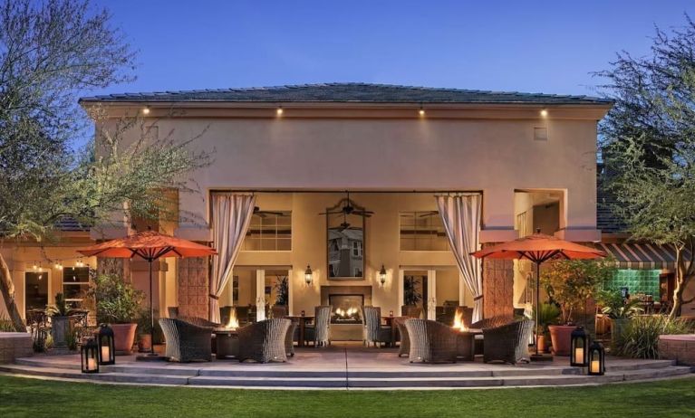 Hotel exterior with outdoor seating at Sonesta Suites Scottsdale Gainey Ranch.