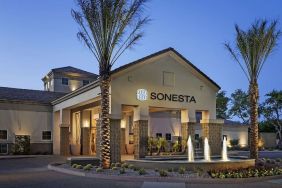 Hotel exterior and parking at Sonesta Suites Scottsdale Gainey Ranch.