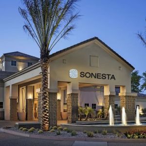 Hotel exterior and parking at Sonesta Suites Scottsdale Gainey Ranch.