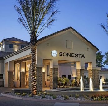 Hotel exterior and parking at Sonesta Suites Scottsdale Gainey Ranch.