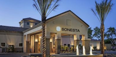 Hotel exterior and parking at Sonesta Suites Scottsdale Gainey Ranch.