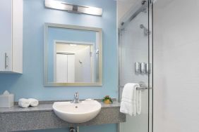 Guest bathroom with shower at Sonesta ES Suites New Orleans.