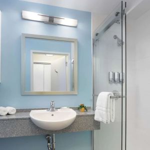 Guest bathroom with shower at Sonesta ES Suites New Orleans.