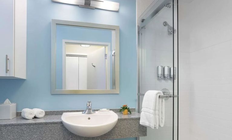 Guest bathroom with shower at Sonesta ES Suites New Orleans.