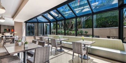 Dining area with natural light at Sonesta Los Angeles Airport LAX.