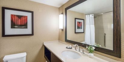 Guest bathroom with shower at Sonesta Los Angeles Airport LAX.