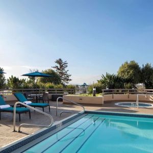 Outdoor pool with seating area at Sonesta San Jose.