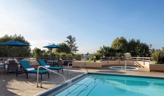 Outdoor pool with seating area at Sonesta San Jose.