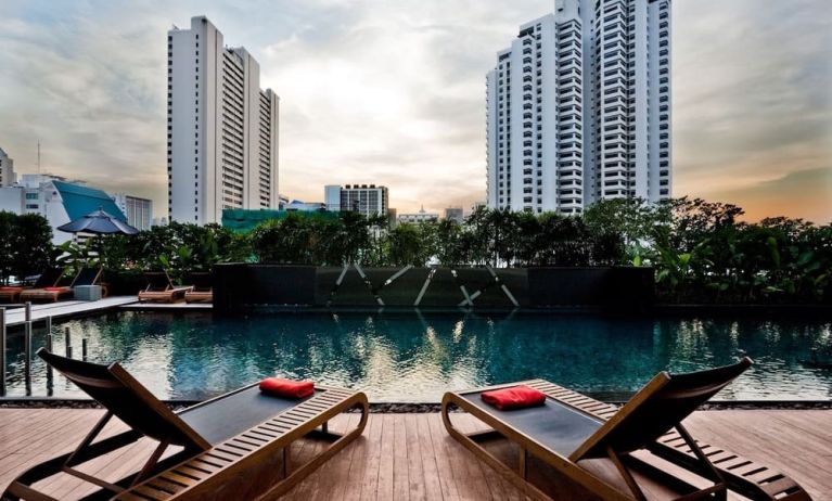 Ourdoor pool with pool loungers at Fraser Suites Sukhumvit, Bangkok.