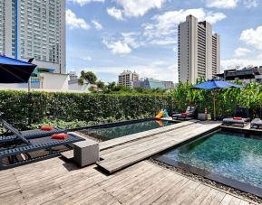 Luxurious outdoor pool with city view at Fraser Suites Sukhumvit, Bangkok.