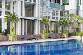 Hotel pool with pool chairs at Fraser Residence Sudirman Jakarta.