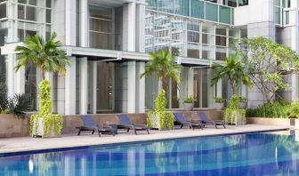 Hotel pool with pool chairs at Fraser Residence Sudirman Jakarta.