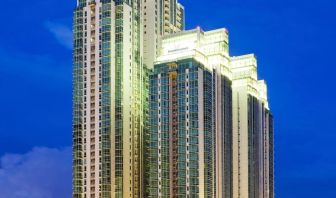 Hotel exterior at night at Fraser Residence Sudirman Jakarta.