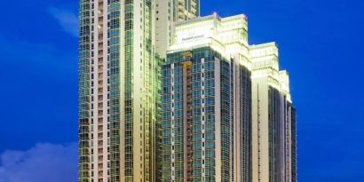 Hotel exterior at night at Fraser Residence Sudirman Jakarta.