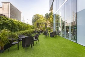 Outdoor garden with seating area at Modena By Fraser Bangkok.