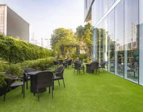 Outdoor garden with seating area at Modena By Fraser Bangkok.