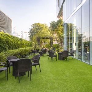 Outdoor garden with seating area at Modena By Fraser Bangkok.