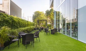 Outdoor garden with seating area at Modena By Fraser Bangkok.