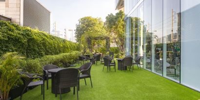 Outdoor garden with seating area at Modena By Fraser Bangkok.