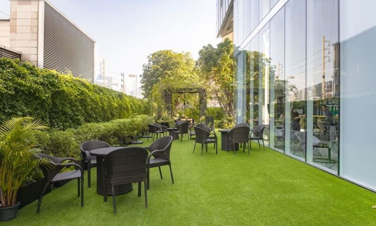 Outdoor garden with seating area at Modena By Fraser Bangkok.