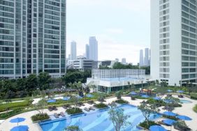 Outdoor pool with lounge chairs at Fraser Place Setiabudi Jakarta.