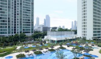 Outdoor pool with lounge chairs at Fraser Place Setiabudi Jakarta.